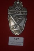 German WWII Demjansk Shield (1942), zinc example with crossed swords and aircraft motif.