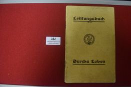 A Third Reich Leistungsbuch (performance record book), tan card covers bearing Reich eagle emblem,