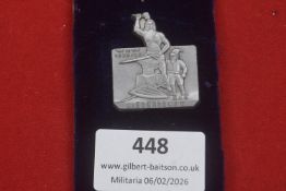 Third Reich Winter Relief (WHW) 1939/40 Gau Niederdonau badge, depicting a blacksmith at an anvil