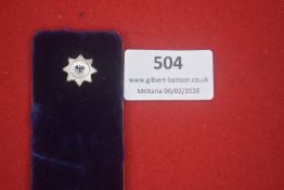 Small German eight-pointed star badge with central national eagle device. Silvered finish,