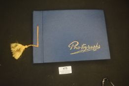 A photograph album containing a mixed group of mid-20th-century photographs, including school