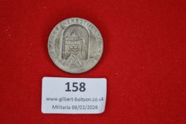 German commemorative tinnie, circular form depicting the Hermannsturm monument and inscribed “