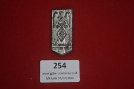 German Hitler Youth badge, elongated shield form bearing eagle above diamond HJ emblem and motto “