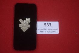 National Socialist women’s organisation badge, oakleaf and acorn motif with swastika, silvered