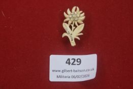 Carved bone Edelweiss flower insignia, traditionally associated with Alpine units, the reverse
