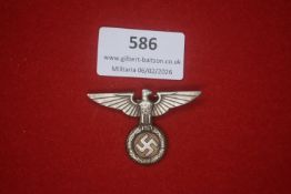 Third Reich political visor cap eagle and wreath badge. Cast alloy example featuring spread-winged