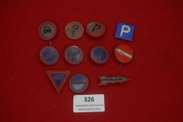 A group of German miniature road sign badges, comprising painted metal examples in circular,