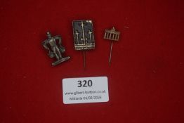 A small group of German metal stick pins and badges, including a Postbote / postal worker figure,