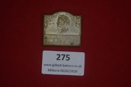 German patriotic enamel badge depicting a standing haloed figure, likely St Sebastian, against a