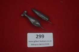 Two German novelty stick pins in the form of aerial bombs, darkened metal examples
