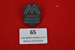 German Leipziger Frühjahrsmesse 1929 badge. Shield-shaped blackened metal example with stylised “