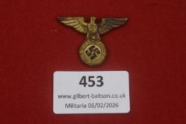 Third Reich political eagle badge with wreath and swastika, gilt-tone metal construction, detailed