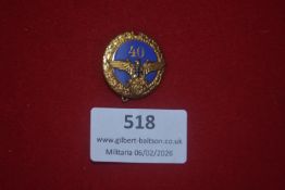German 40-year service or anniversary badge, gilt wreath surrounding blue enamel centre marked “40”,
