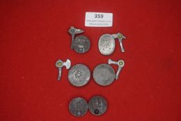 A mixed group of German WHW miniature weapon-themed badges, comprising small axe-head and shield