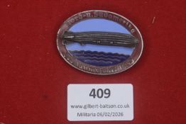 A Third Reich Nord- und Südamerika Jubiläumsfahrt 1933 badge, oval with airship motif over