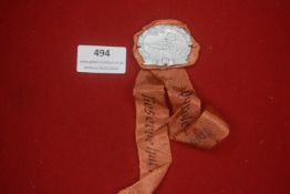 German Third Reich shooting tinnie, oval aluminium example depicting a soldier aiming a rifle within