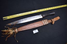 Ethnographic short sword or large knife, likely African, with single-edged blade showing forge marks
