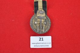 German commemorative medal with ribbon, circular bronze-toned example with applied wreath and