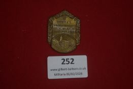 German regional hiking or sporting badge, shield-shaped with townscape vignette and inscription “