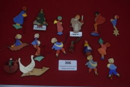 A large group of German WHW carved wooden figures, dated 1934, being hand-painted Winterhilfswerk