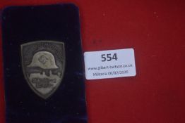 German Nürnberg rally commemorative badge, shield-shaped alloy example bearing steel helmet with