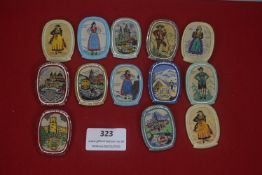 A large group of German WHW woven fabric plaques, oval form, depicting regional costumes, heraldic