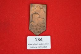 German regional festival badge, shield-shaped bronze issue depicting fortified tower and mountain