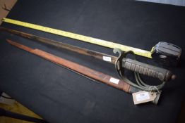 British cavalry officer’s sword with single-edged blade, etched with the Royal coat of arms and