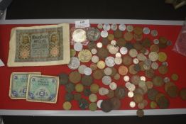 A large and varied accumulation of world coins, tokens and paper currency, including British,
