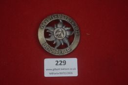 German patriotic or veterans’ badge, circular openwork design featuring a central flower and