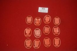 A group of German red plastic WHW donation badges, oval form, depicting city arms and monuments
