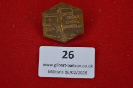 German Schutzbund commemorative badge, hexagonal bronze-toned example depicting nude athletic