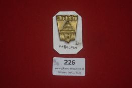 German Third Reich Winterhilfswerk (WHW) donation badge, gilt metal example bearing the