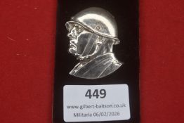 Third Reich silvered metal profile badge depicting a German soldier wearing a steel helmet, finely
