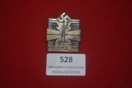 German Kreisturnfest Urach 1934 badge, shield-shaped die-struck alloy example featuring monument and