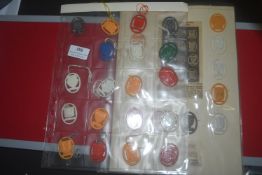 A collection of German plastic WHW donation badges, oval form, in assorted colours, depicting city