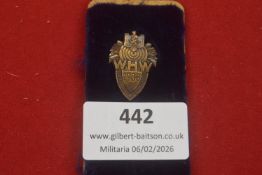 A Third Reich WHW 1938 tinnie badge of shield form, featuring a central target motif and eagle