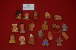 A large mixed group of German WHW ceramic miniatures and badges, including busts, character heads,