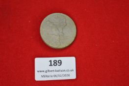 German commemorative badge, circular, showing a stylised figure balancing on a wheel above a