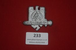 German SA Wehrkampf 1940 badge, cast light alloy example depicting SA emblem within a castellated
