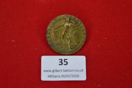 German athletic festival commemorative badge, circular bronze-toned example depicting nude discus