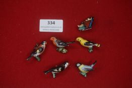 A small group of German ceramic novelty badges in the form of birds and butterflies, hand-painted
