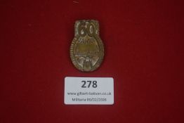 German commemorative badge marked 60 Jahre, featuring a townscape with church spires and surrounding