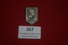 German Third Reich commemorative badge, shield-shaped, depicting profile portrait above the