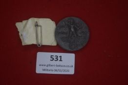 German stoneware / composition commemorative tinnie, circular example depicting a standing male