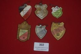 Group of six German cardboard commemorative badges, 1920s–1930s, for shooting, singing and club