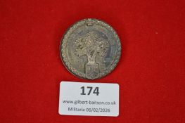 German memorial or veterans’ badge depicting an oak tree above a shield, with Iron Cross at top