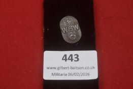 A Third Reich WHW regional donation badge of oval form, bearing the WHW monogram with heraldic