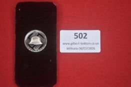 German Stahlhelm Bund badge, circular example featuring a steel helmet within a cogwheel. Silvered
