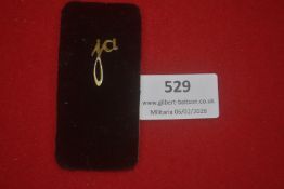 Small German gilt stick pin, stylised letterform design, mounted on original black velvet display